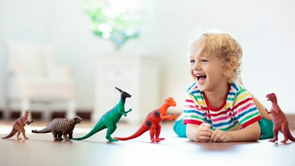Boy playing with dinosaur figures