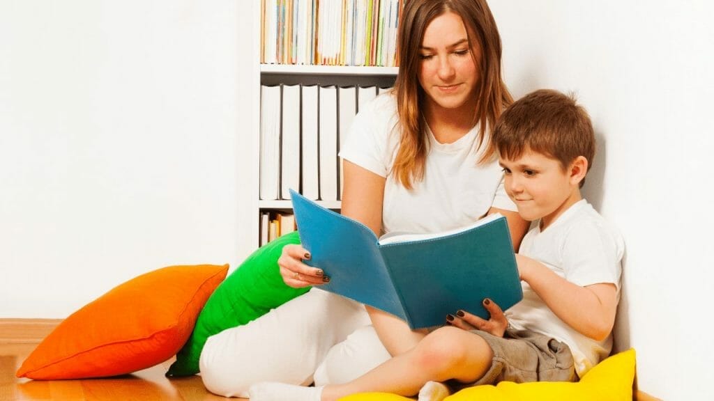 Mother is reading a story to her son about choking prevention